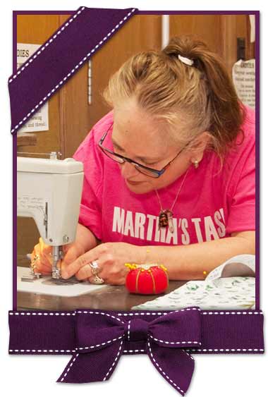 Woman sewing at Martha's Task.